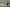 Editorial image of woman in white linen floating in water