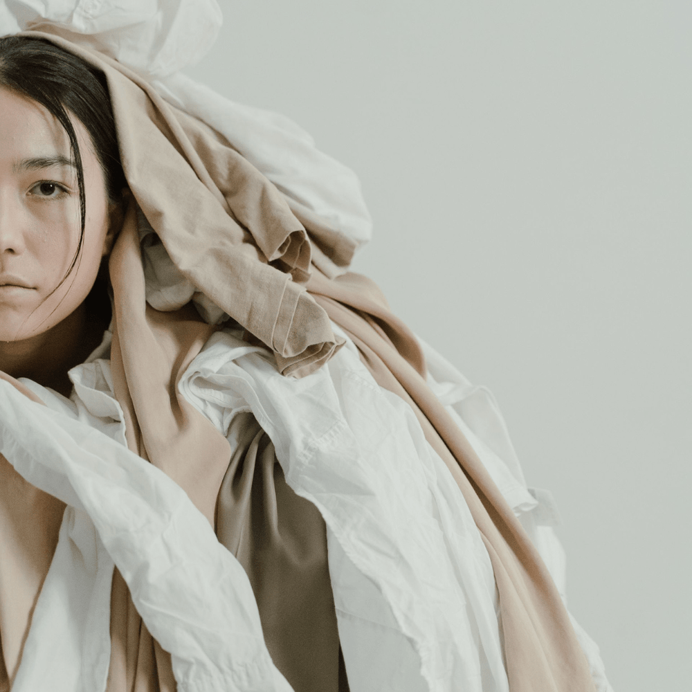 Archetype - Taurus woman covered in comfort clothing and linens