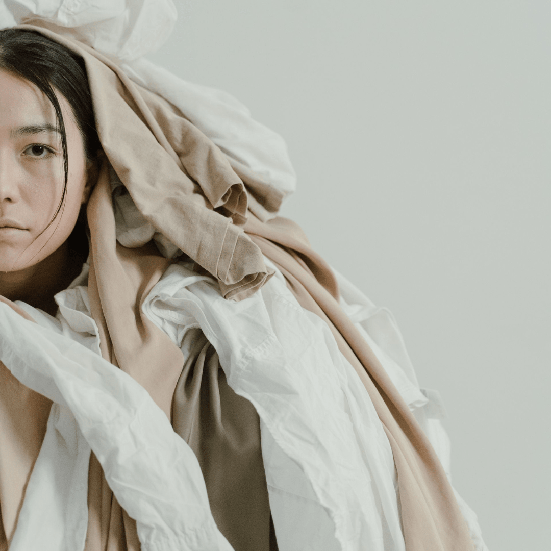 Archetype - Taurus woman covered in comfort clothing and linens