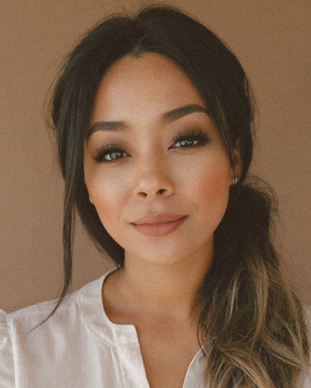 An amber candle labeled Morning Affirmations by Alchemist + Co. in front of a coffee maker and can of ground coffee