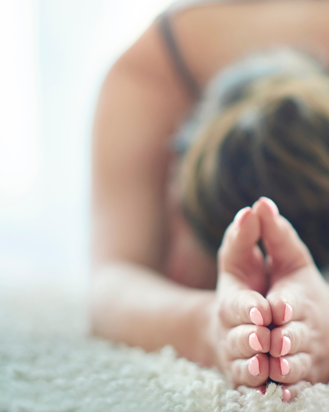 Woman practicing wellness rituals in a yoga pose.