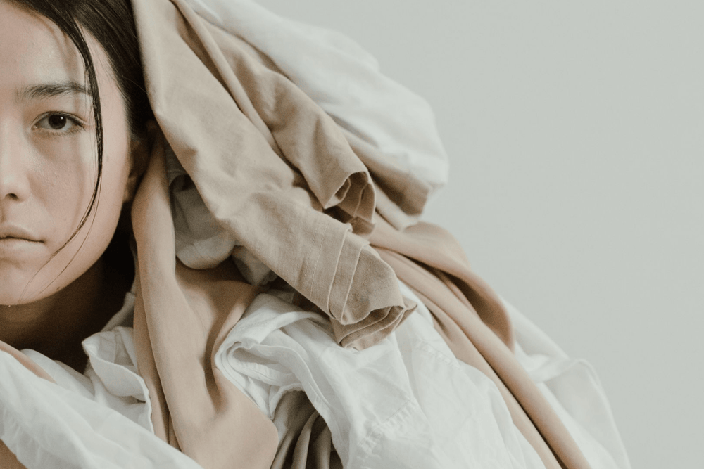 Archetype - Taurus woman covered in comfort clothing and linens