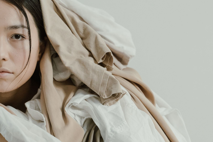 Archetype - Taurus woman covered in comfort clothing and linens