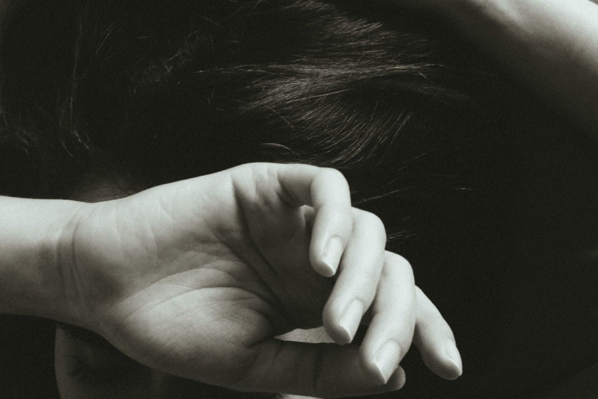 Editorial image of a woman shielding her face