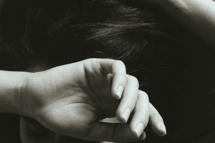 Editorial image of a woman shielding her face