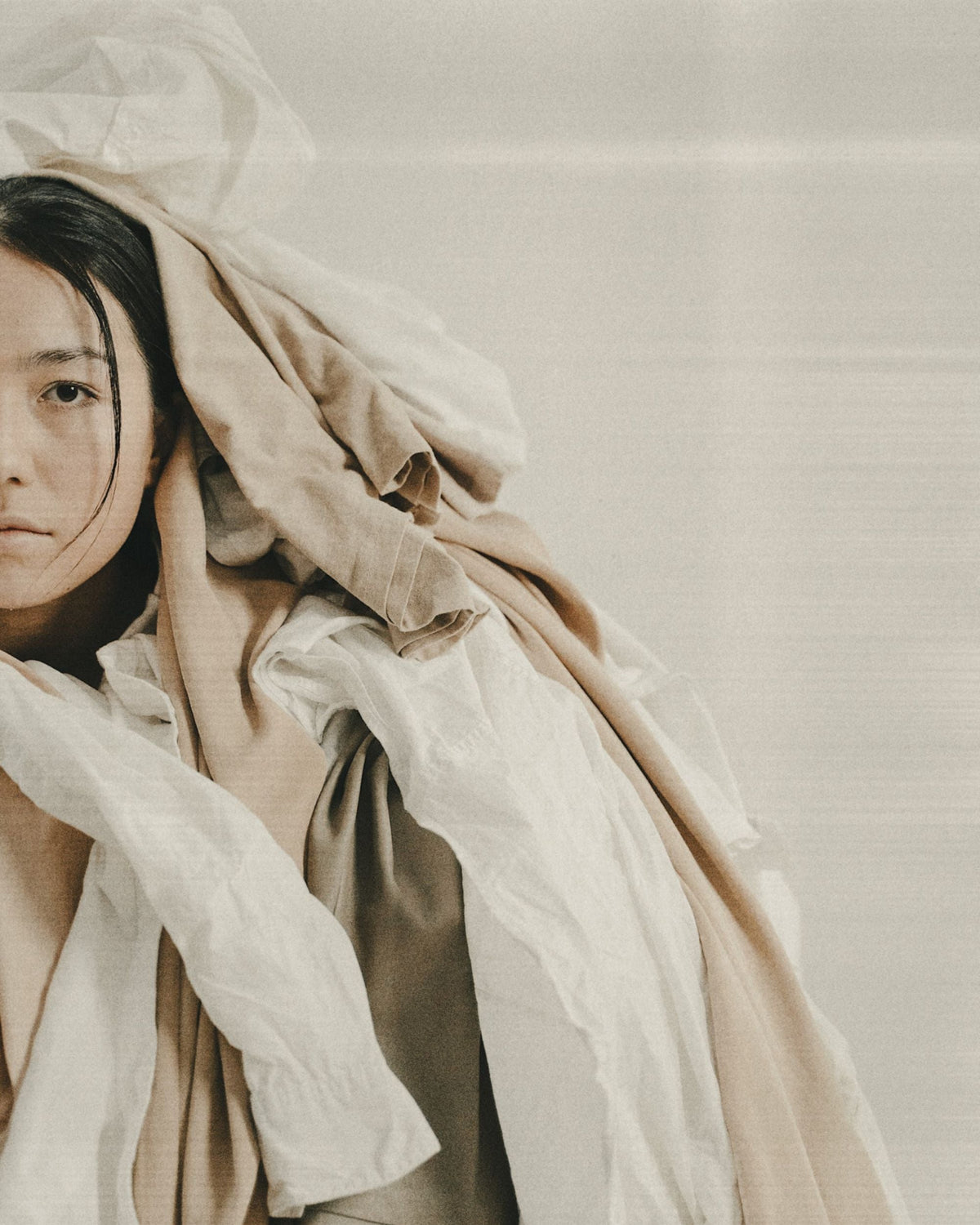 Archetype - Taurus woman covered in comfort clothing and linens