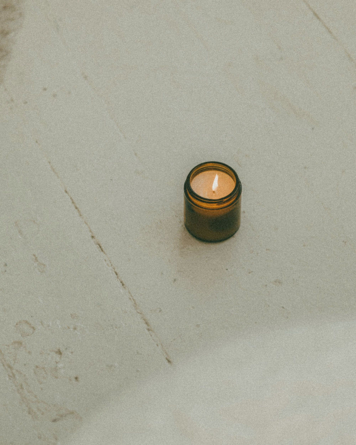 Two Palo Santo candles with crystals and botanicals by Alchemist + Co.