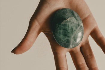 Tumbled green aventurine on an open palm