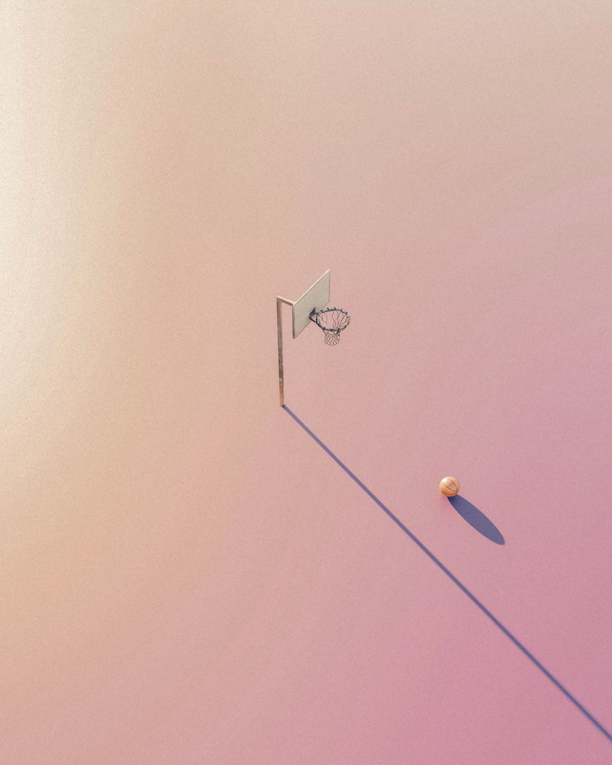 A hand holding a compass with no clear direction against mountainous terrain.