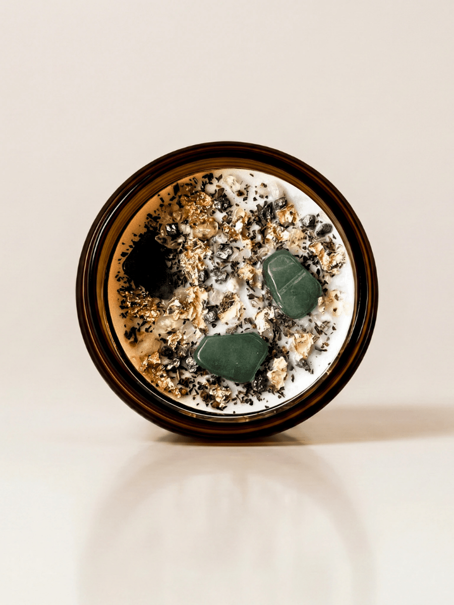Abundance ritual candle with green aventurine and botanical details viewed from above 