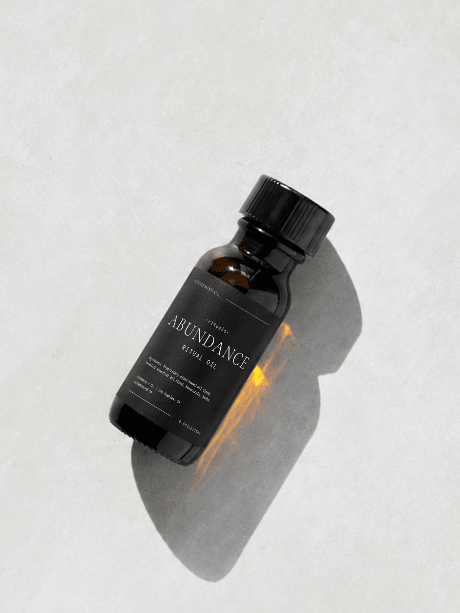 Bottle of 'Abundance' ritual oil on a light gray background.