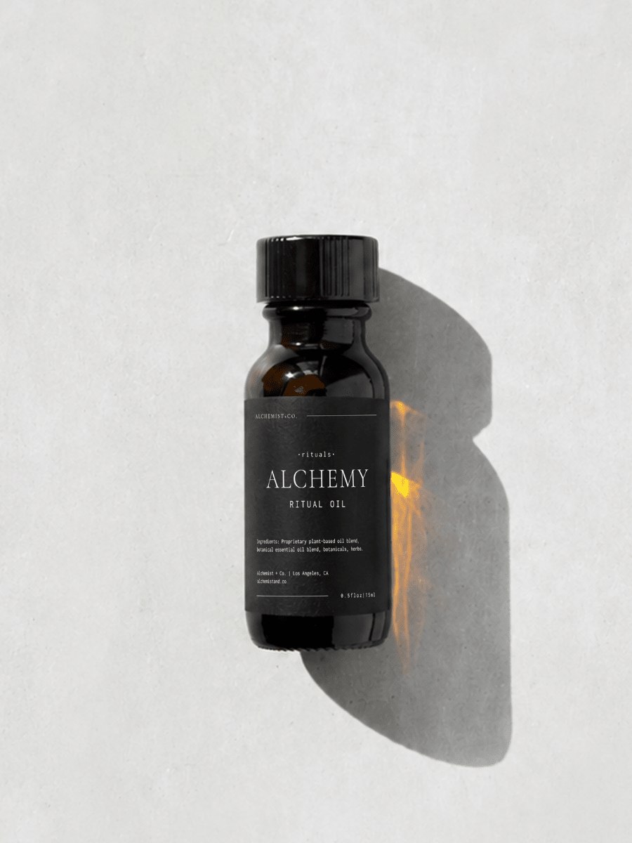 Bottle of 'Alchemy' ritual oil on a light gray background.
