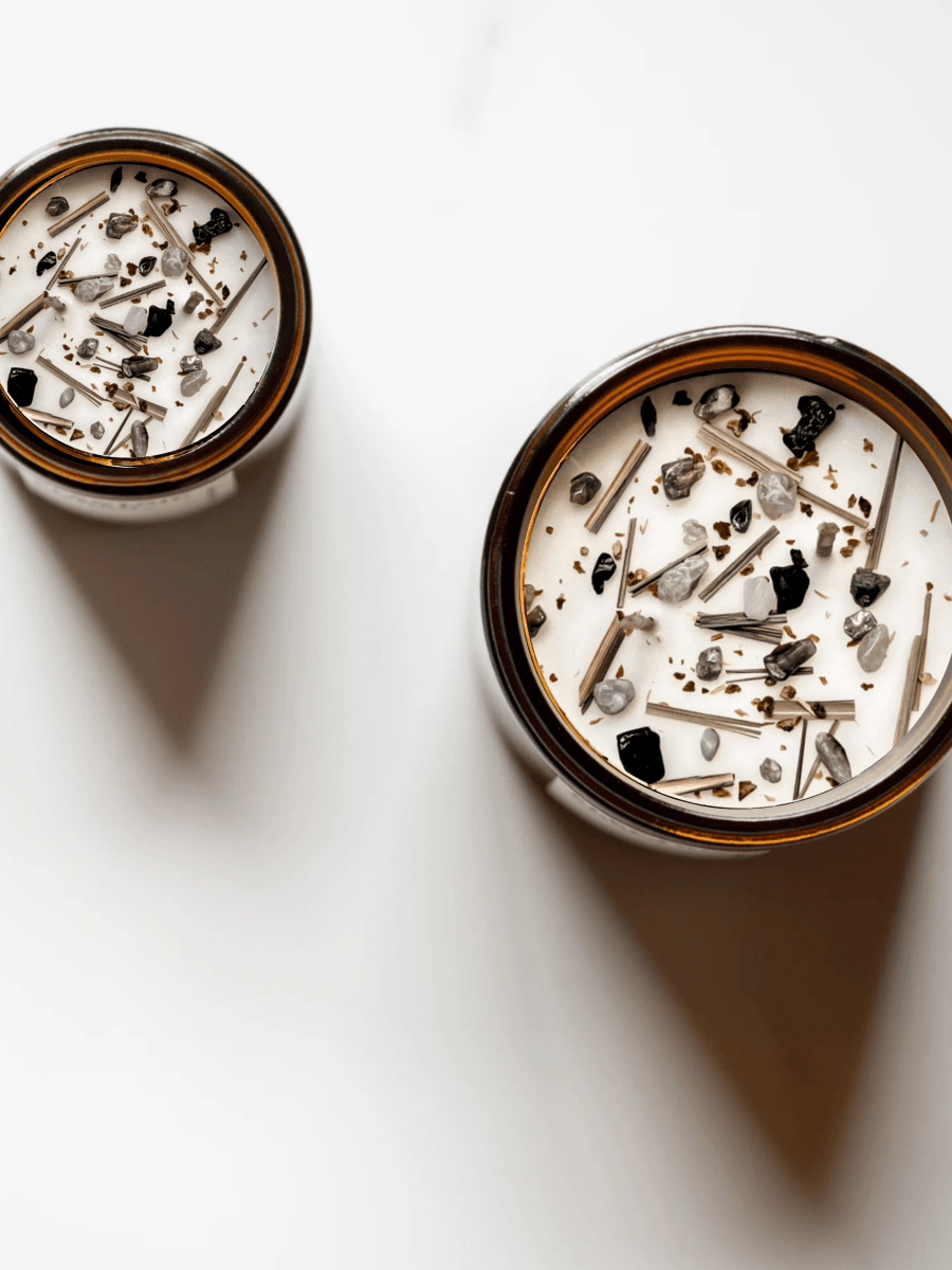 Top view of Alignment ritual candles with rainbow tourmaline, quartz, black tourmaline, and botanicals.