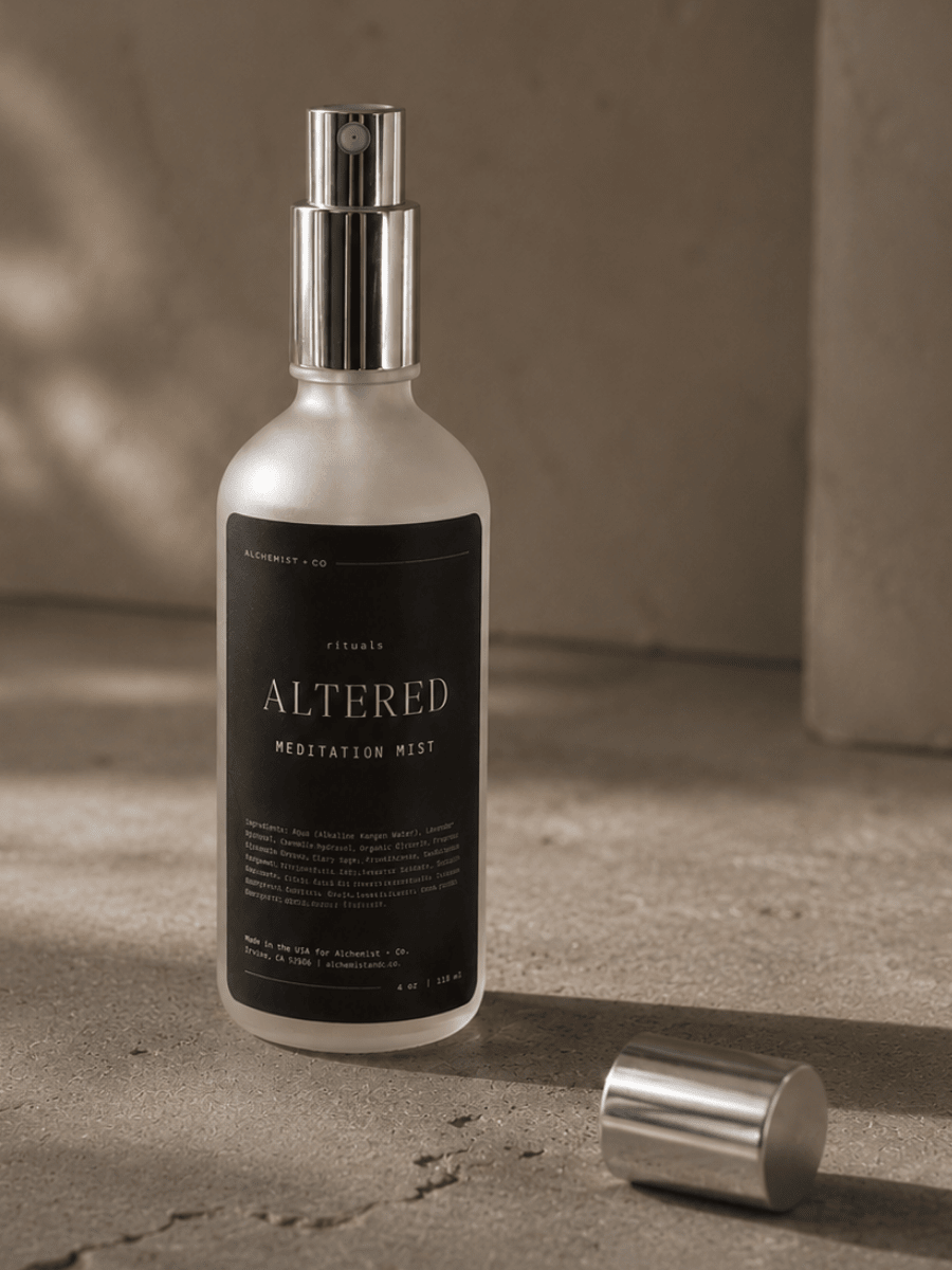 Bottle of 'Altered Meditation Mist' on a textured surface with a neutral background.