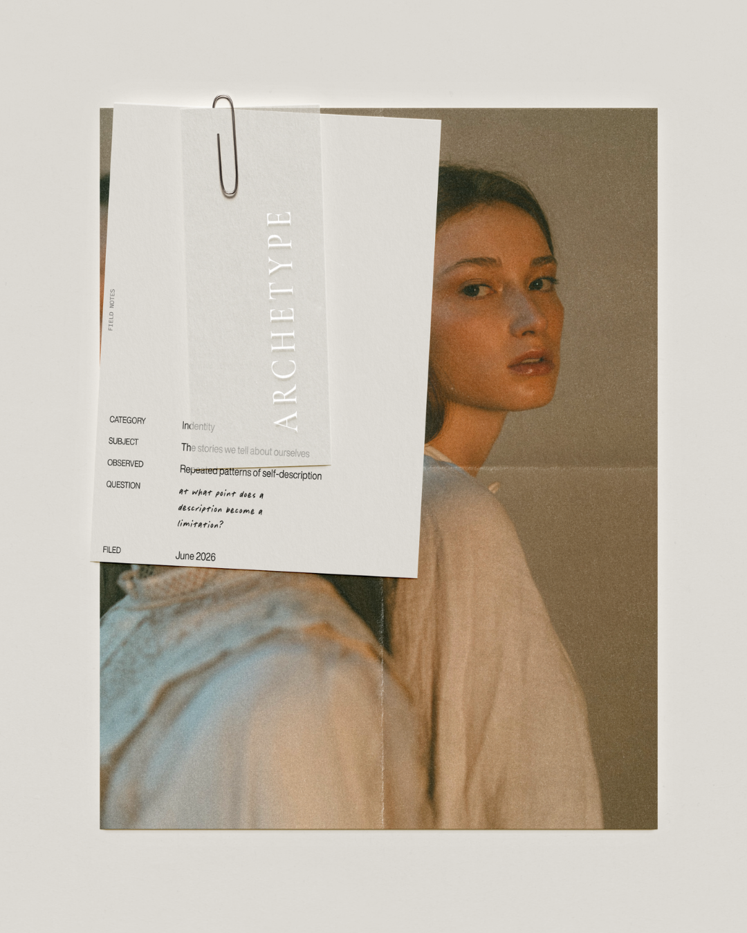 File documents with an image of a woman and text overlay for Archetype Zodiac Collection by Alchemist + Co. on a neutral paper background.