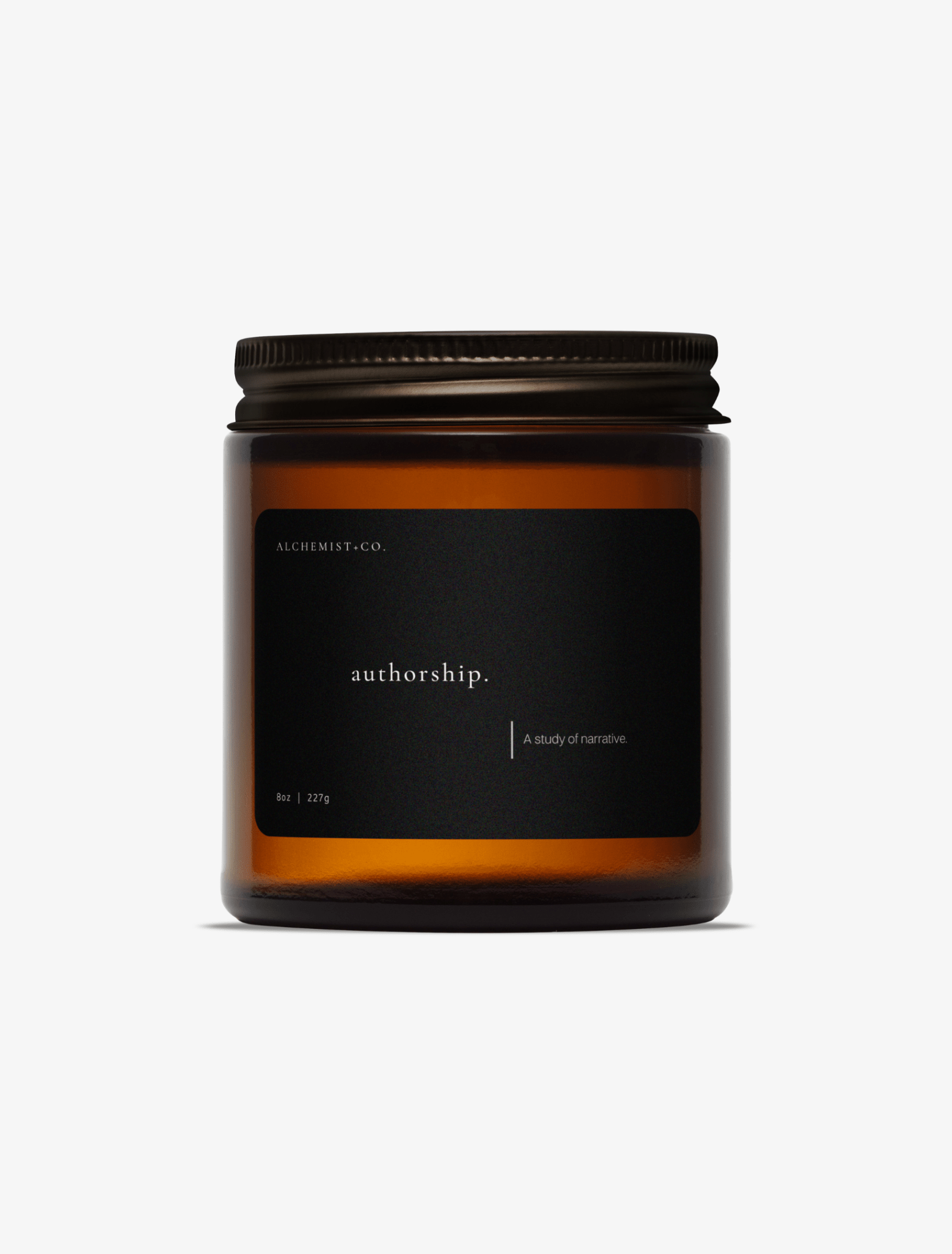 An amber glass jar candle with a black label and a dark metal lid, centered on a light gray background. The label reads 'Authorship'.