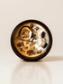 Ayahuasca ritual candle with botswana agate, peridot, quartz, and botanical details viewed from above.