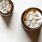 Top view of Bliss ritual candles with moonstone, quartz, and botanicals.