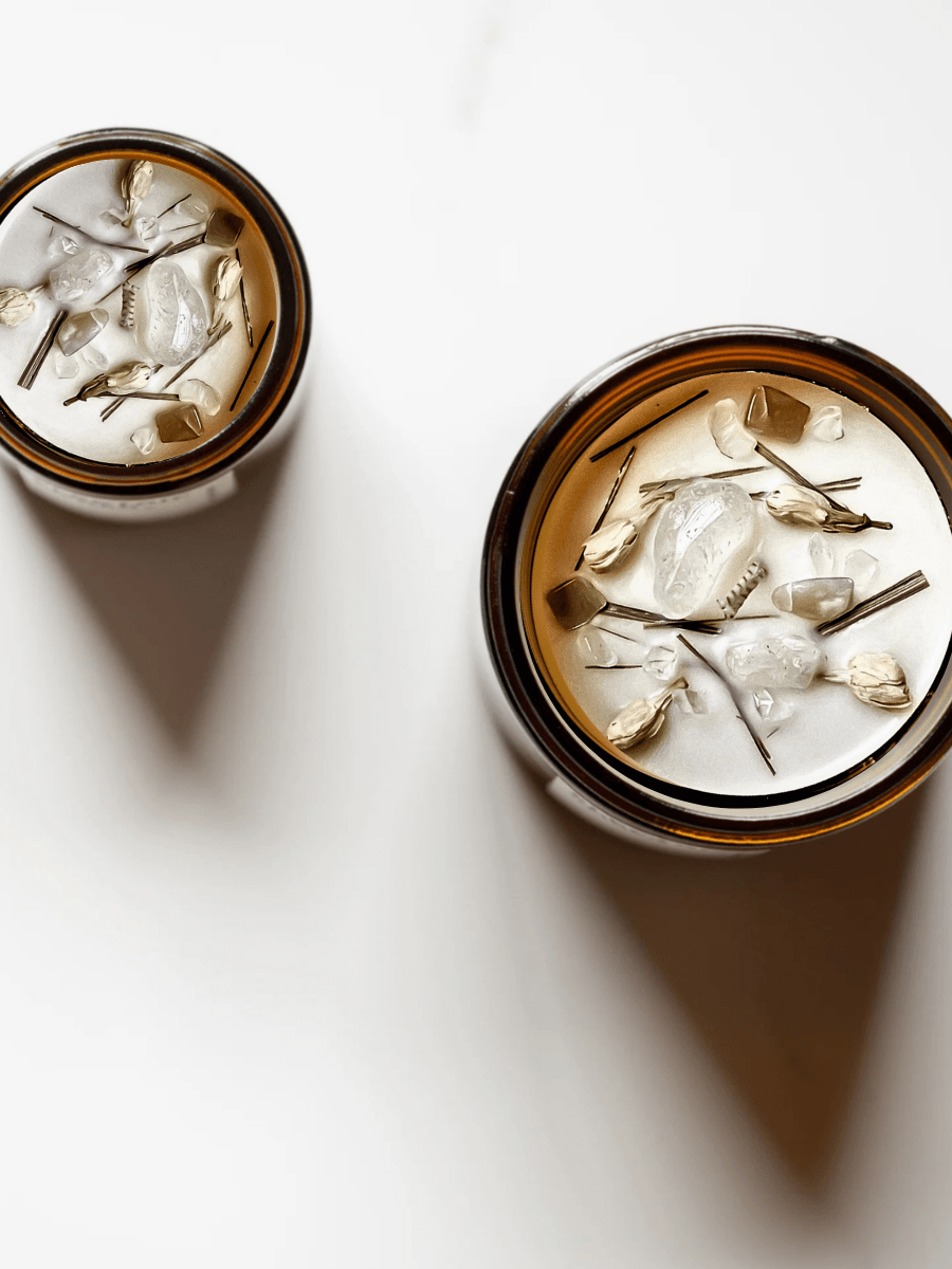 Top view of Bliss ritual candles with moonstone, quartz, and botanicals.