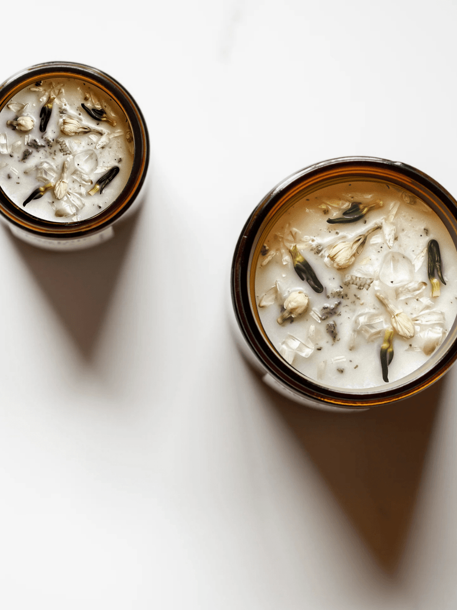 Top view of Breathwork ritual candles with quartz and botanicals.