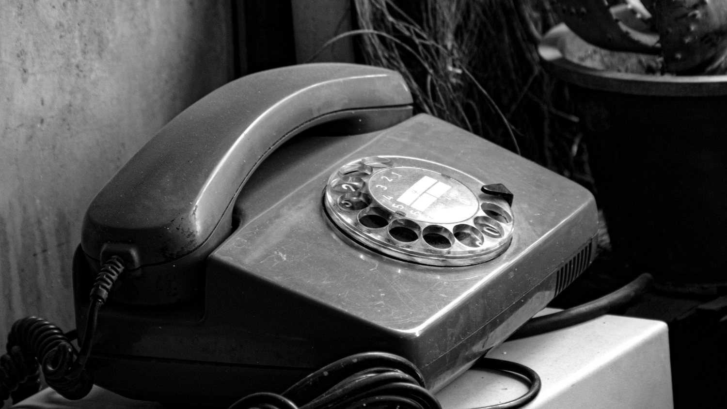 Vintage rotary phone in black and white.