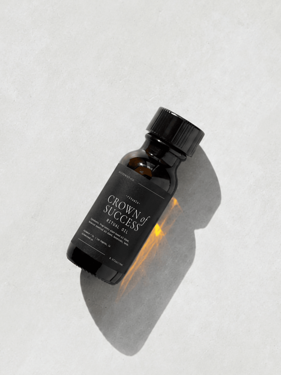 Bottle of 'Crown of Success' ritual oil on a light gray background.