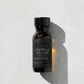 Bottle of 'Crown of Success' ritual oil on a light gray background.
