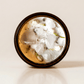 Drift ritual candle with quartz, rose quartz, and botanical detail viewed from above.
