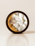 Drift ritual candle with quartz, rose quartz, and botanical detail viewed from above.