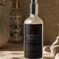 Bottle of 'Florida Water Meditation Mist' on a textured surface with decorative items in the background.