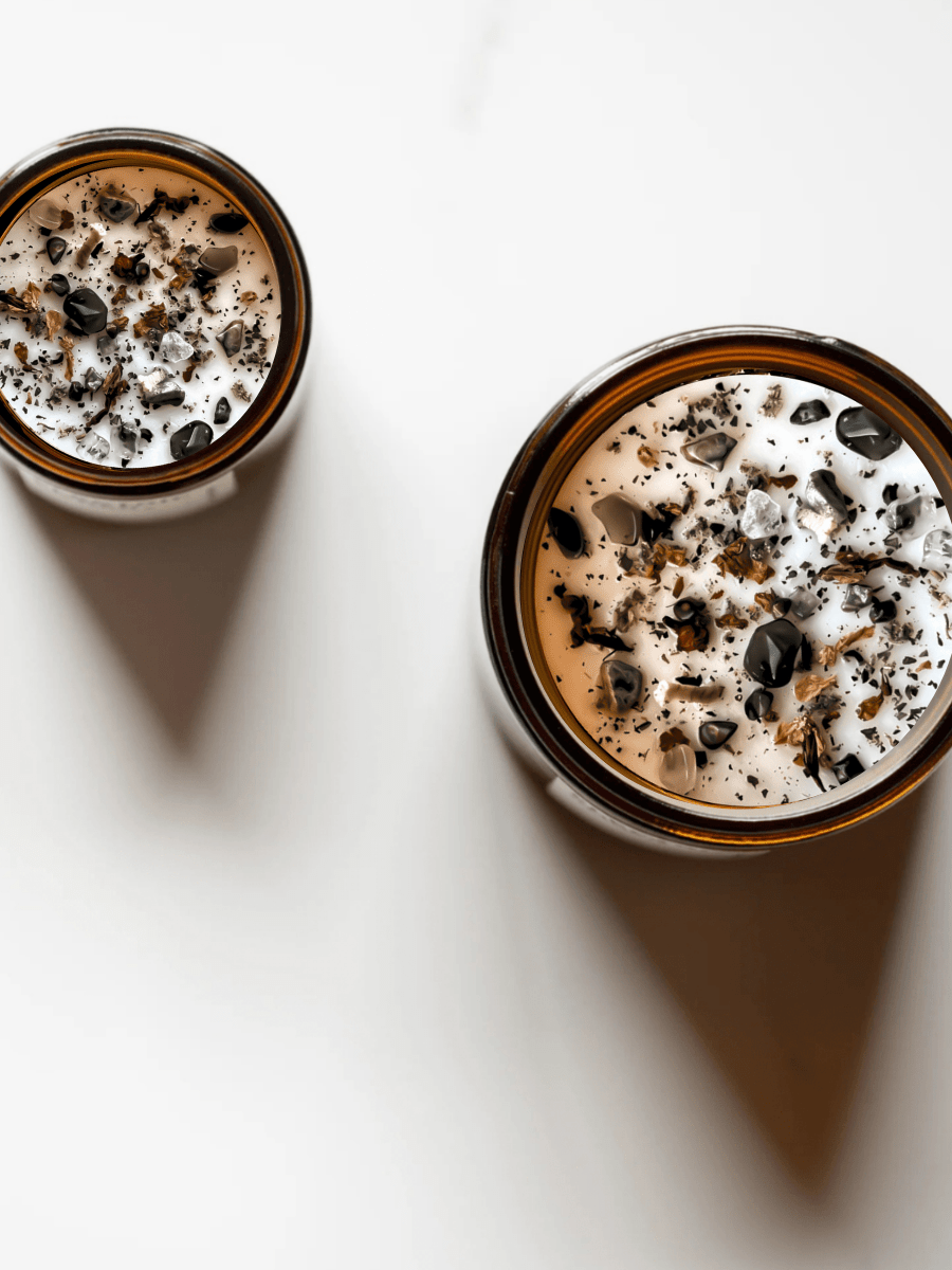 Top view of Gaia ritual candles with rainforest rhyolite, smoky quartz, quartz, and botanicals.