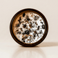 Gaia ritual candle with rainforest rhyolite, smoky quartz, quartz, and botanical details viewed from above.