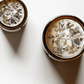 Top view of Gratitude ritual candles with fluorite, rutilated quartz, and botanicals.