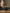 Jar of Palo Santo incense cones on a wooden surface with a blurred vase in the background.