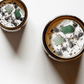 Top view of Heal ritual candles with green aventurine, amethyst, quartz, and botanicals.