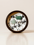 Heal ritual candle with green aventurine, amethyst, quartz, botanical details viewed from above.