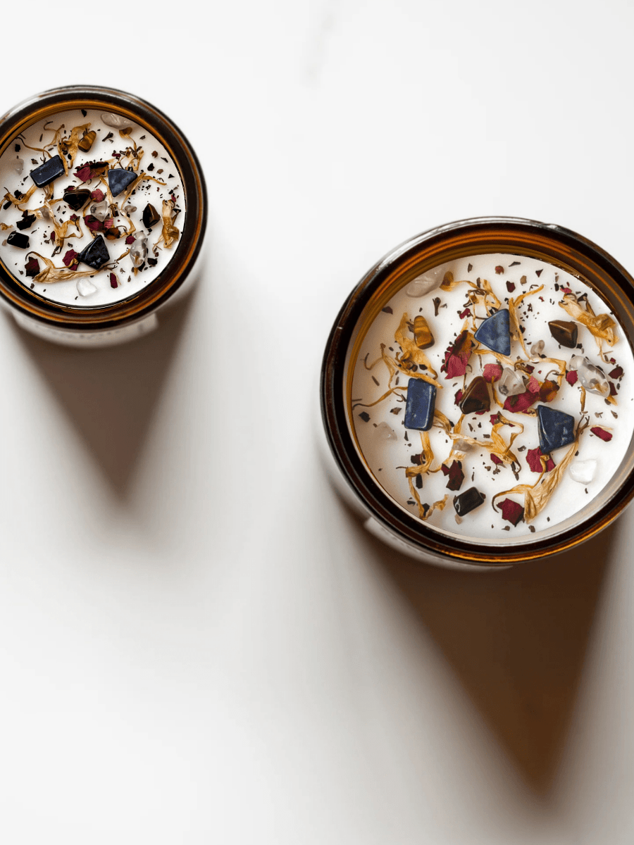 Top view of II. The High Priestess ritual candles with lapis lazuli, tiger's eye, quartz, and botanicals.