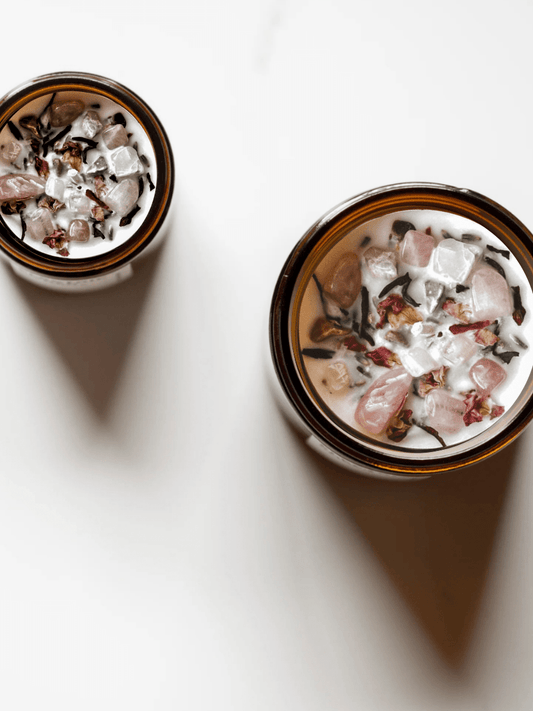 Top view of III. The Empress ritual candles with rose quartz, moonstone, unakite, and botanicals.
