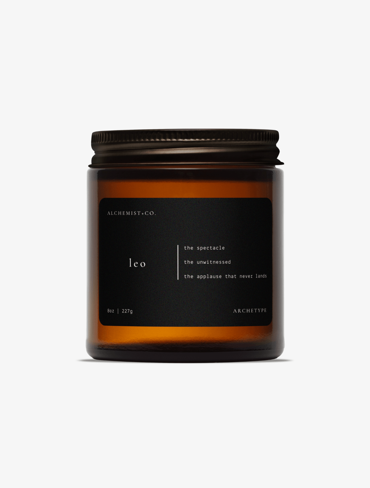 Leo scented candle by Alchemist + Co. in an amber glass jar with a black label
