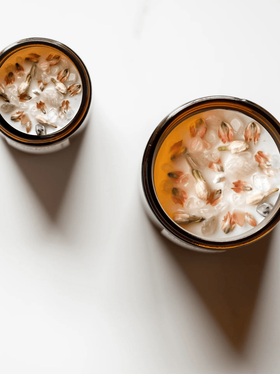 Top view of Lotus ritual candles with rose quartz, quartz, and botanicals.