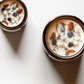 Top view of Meditate ritual candles with carnelian, lapis lazuli, amethyst, and botanicals.