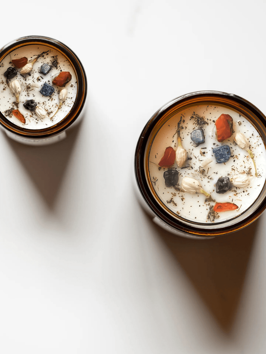 Top view of Meditate ritual candles with carnelian, lapis lazuli, amethyst, and botanicals.