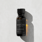 Bottle of 'Moon Juice' ritual oil on a light gray background.