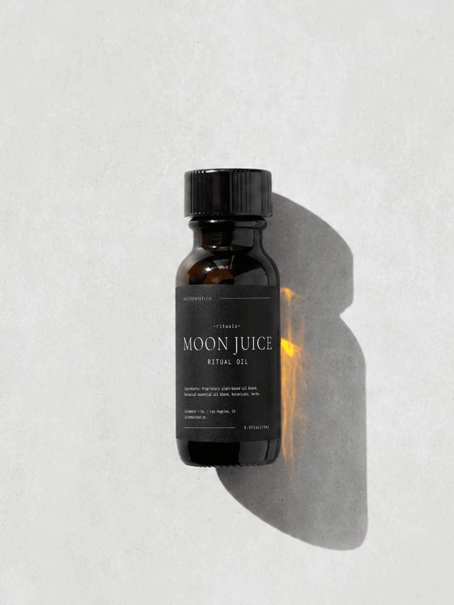 Bottle of 'Moon Juice' ritual oil on a light gray background.