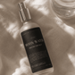 Bottle of 'Moon Water' meditation mist on a textured linen surface