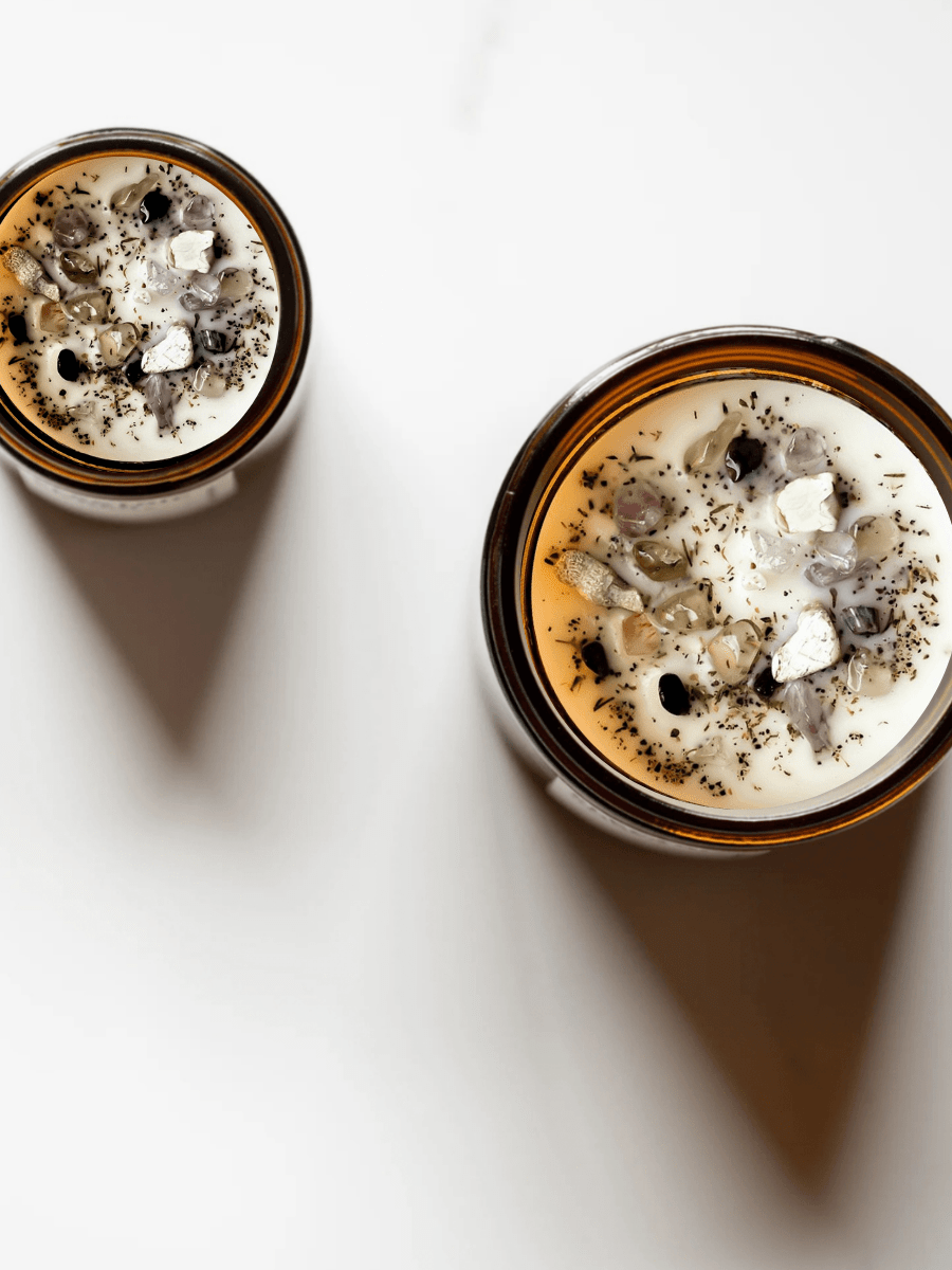 Top view of Morning Affirmations in Hazelnut ritual candles with tiger's eye, moonstone, smoky quartz, super seven, and botanicals.