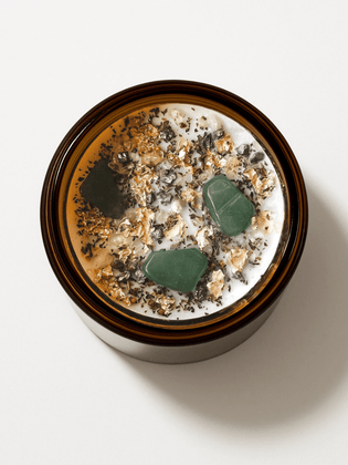 Top view of Abundance Ritual Candle by Alchemist + Co. with crystals and botanicals.