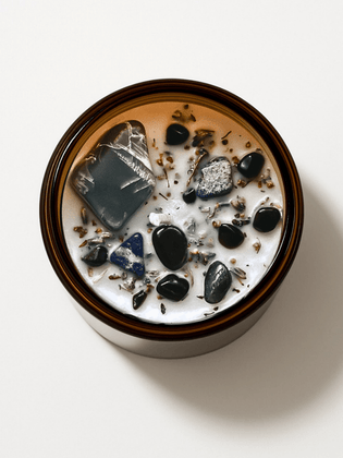 Top view of Alchemist + Co. Shadow Work candle with crystals and botanicals.
