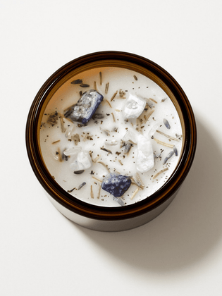 Top view of Alchemist + Co. New Moon Ritual Candle with crystals and botanicals.