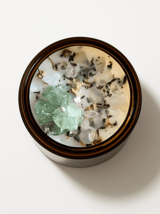 Top view of Alchemist + Co. Release Ritual Candle with crystals and botanicals.